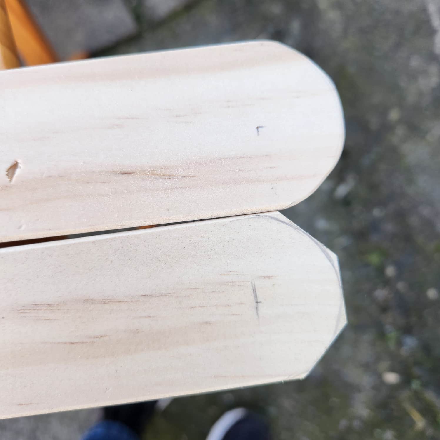 A comparison between the first cut of the table legs with diagonal corners cut off, versus the final sanded round version of the table leg.