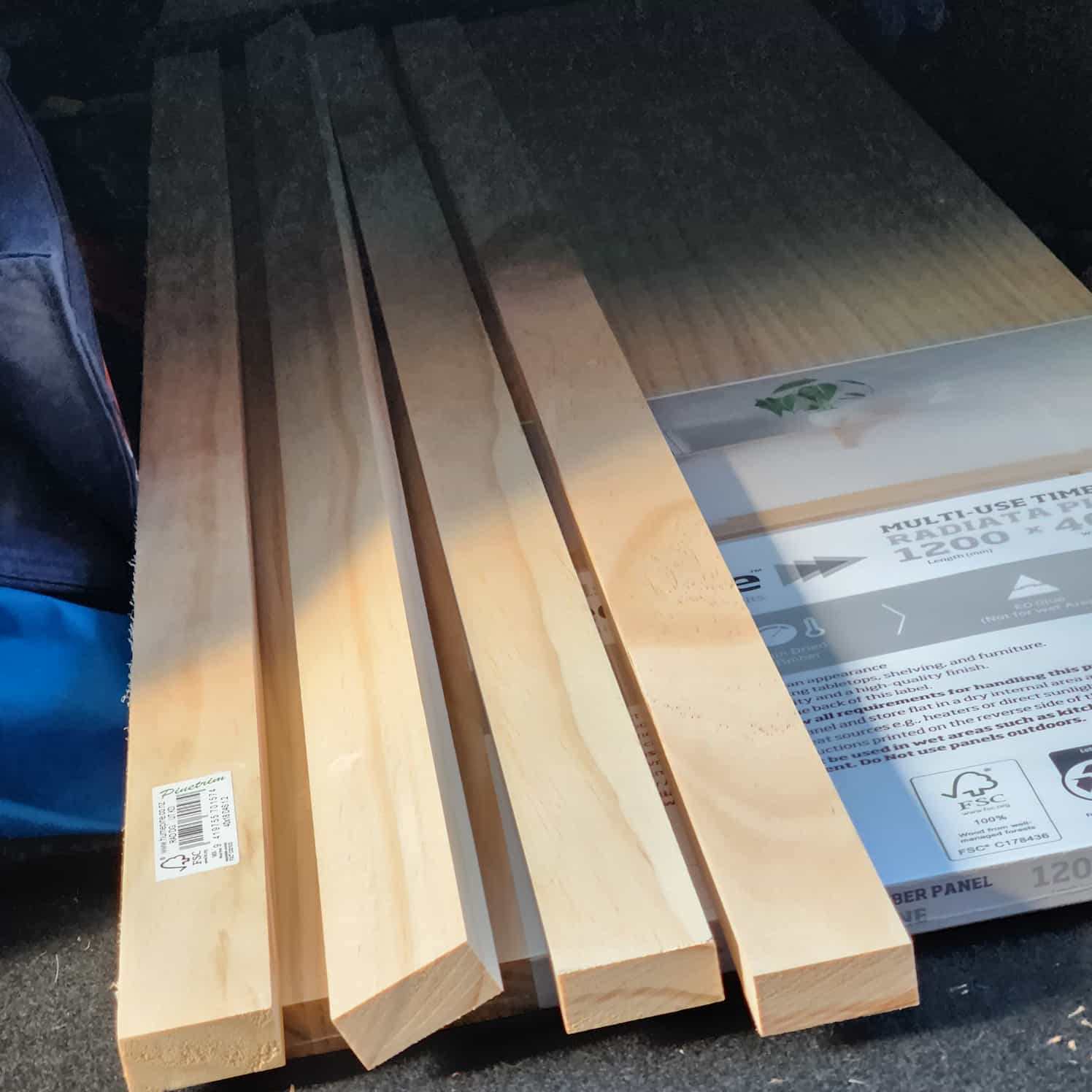 Wood planks of varying sizes with labels still attached.