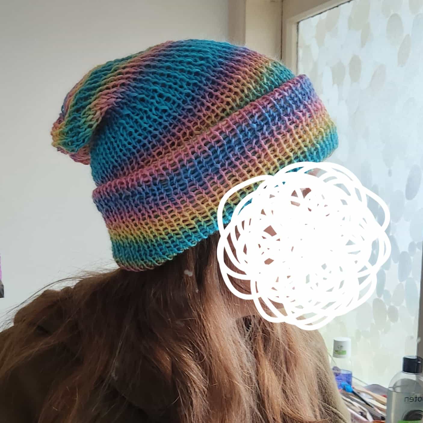 A rainbow-coloured beanie.