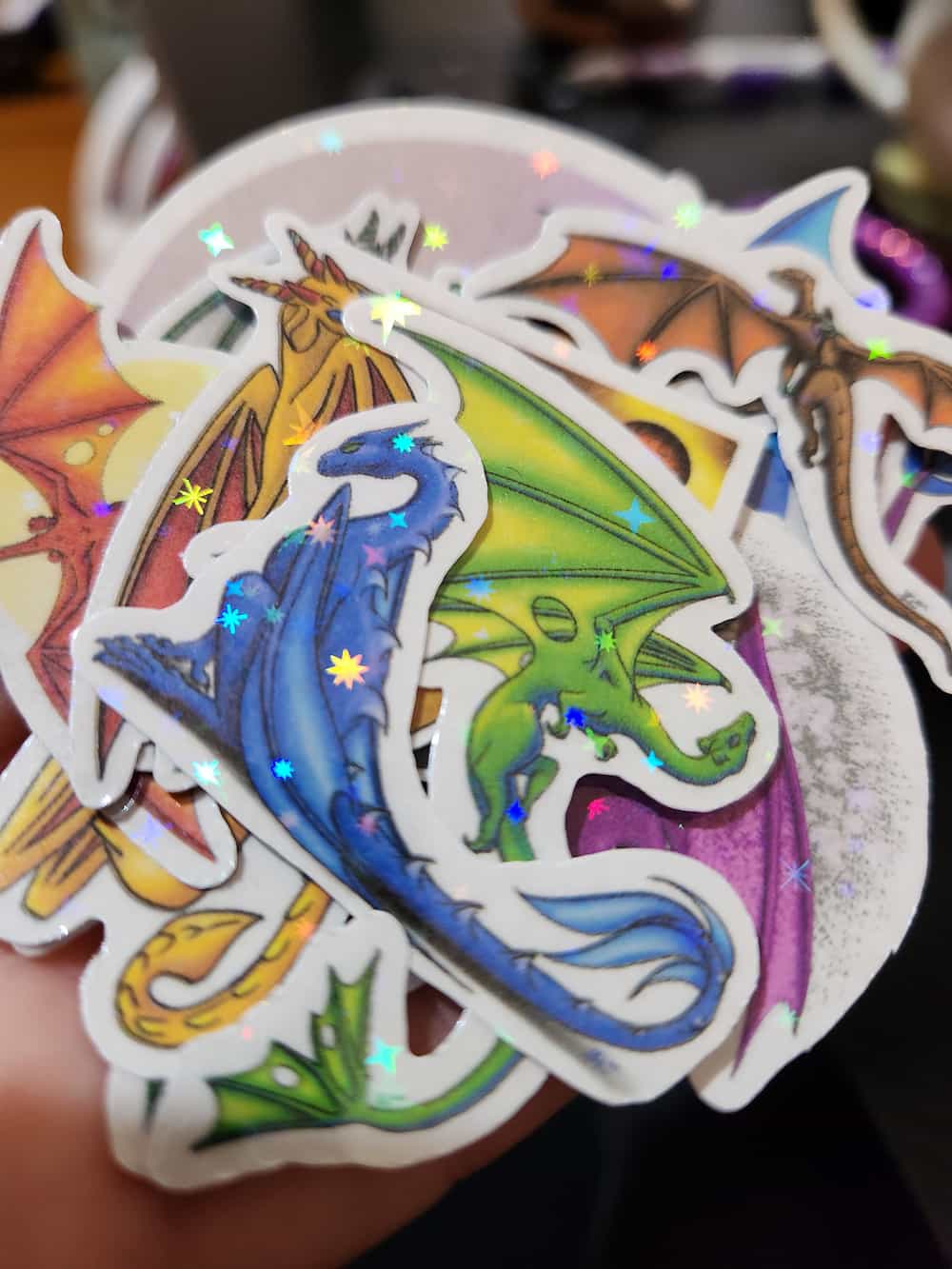 A small pile of die-cut dragon-themed stickers.