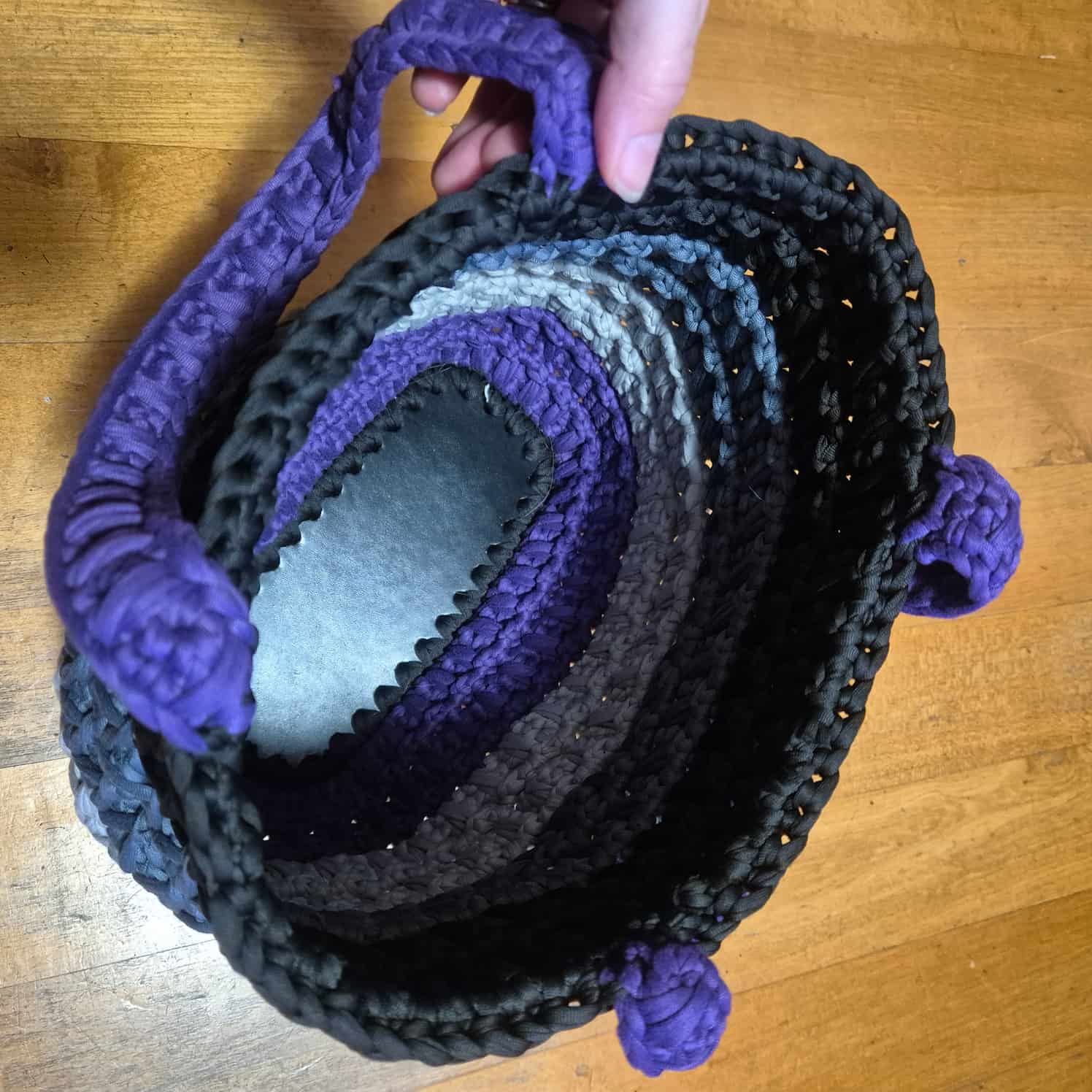 A view of the inside of the bag showing the leather base.