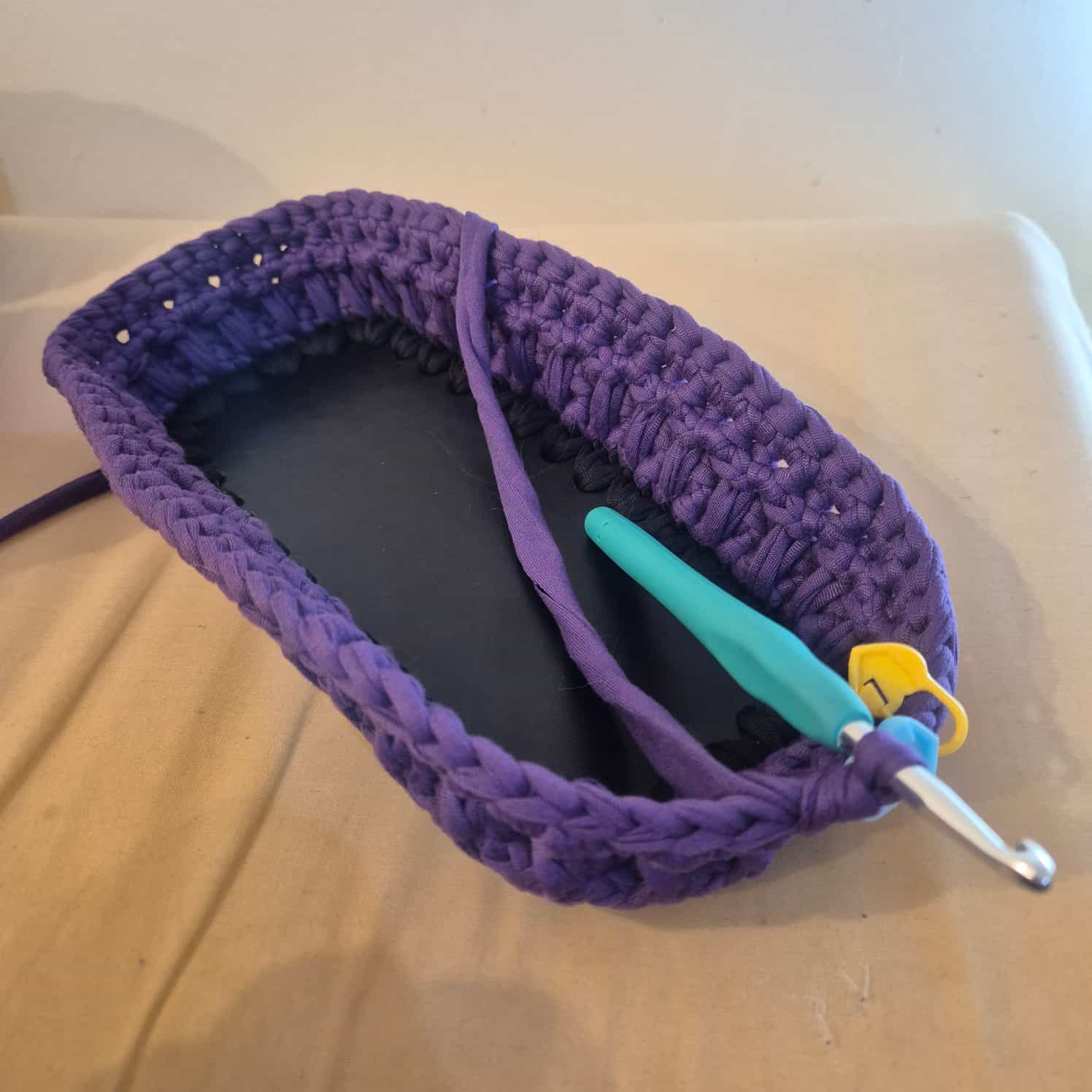 A work-in-progress picture of the bag showing just the base and the completed purple section.